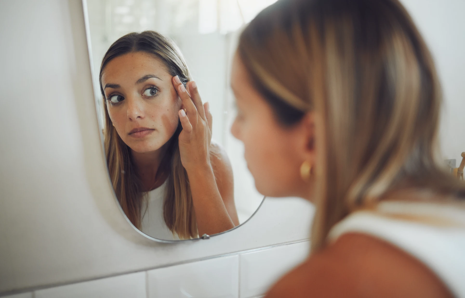 Woman examining skin concerns considering chemical peel treatment at Gold Skin Care Center Nashville
