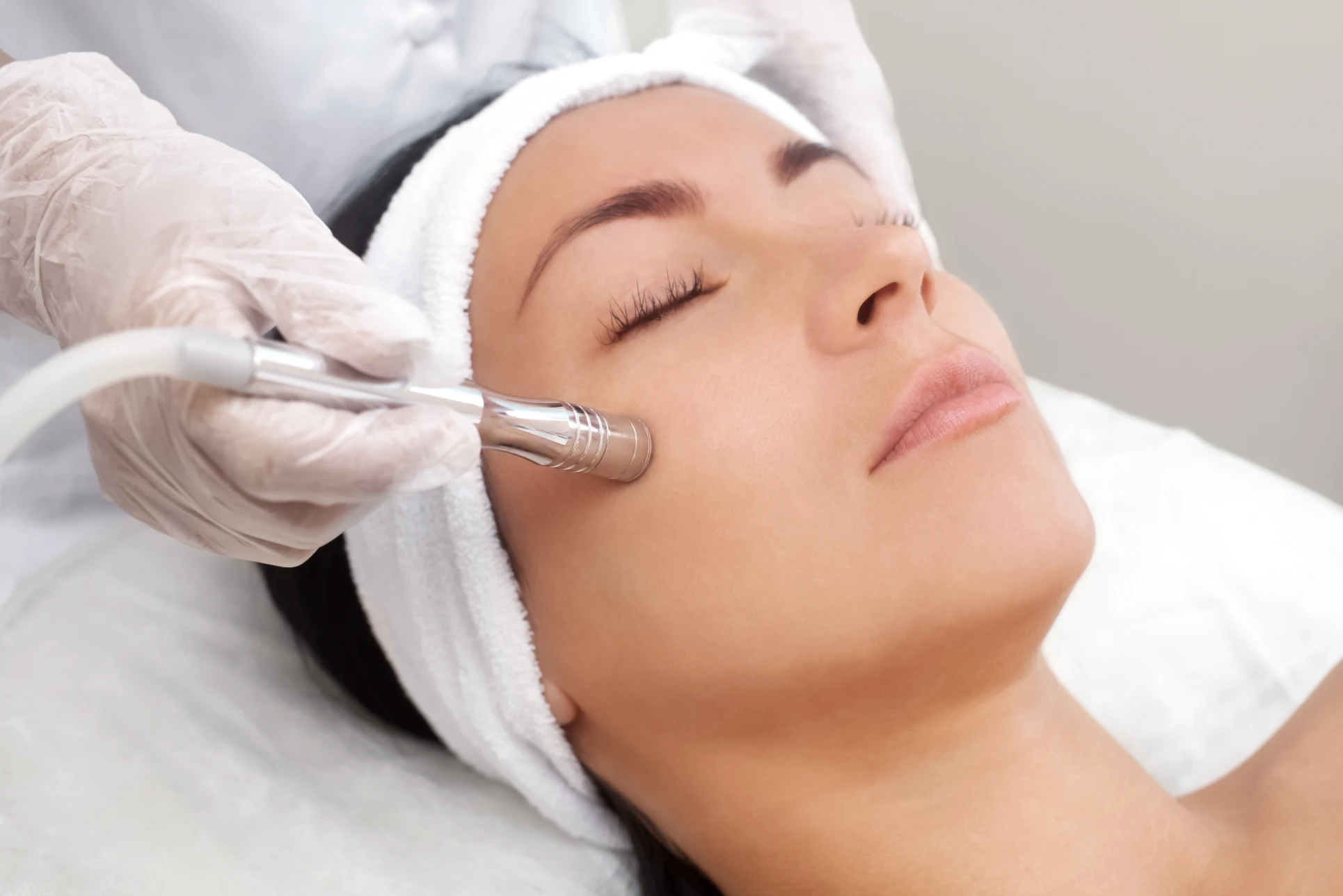 Woman receiving customized microdermabrasion treatment for dull skin and mild acne scars Nashville