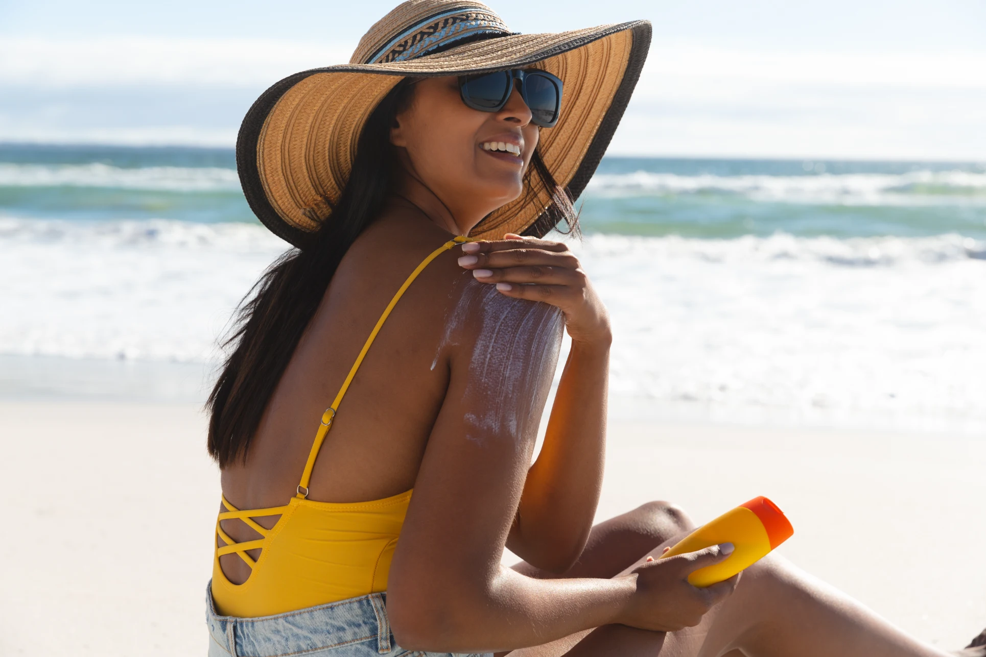 Woman protecting skin from sun damage after acne light treatment at Gold Skin Care Nashville